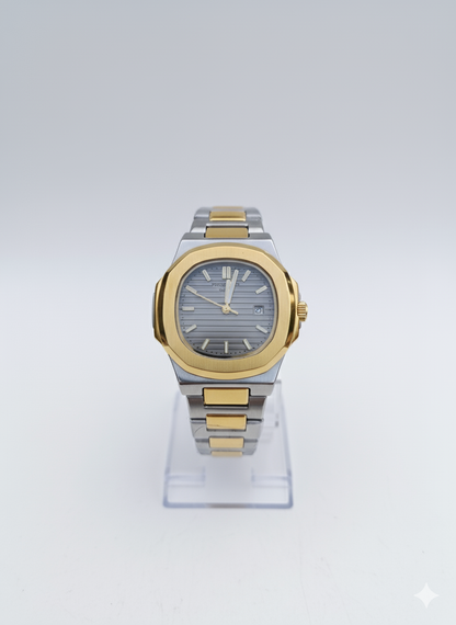 Two-tone watch with silver and gold band on a clear stand against a white background