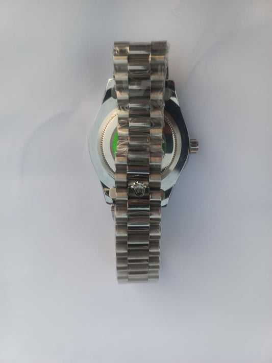 Silver watch with a detailed band on a white background